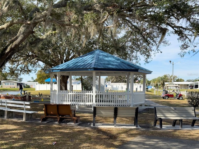 surrounding community featuring fence and a gazebo