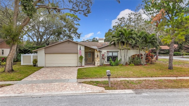 view of front of property with a garage and a front lawn