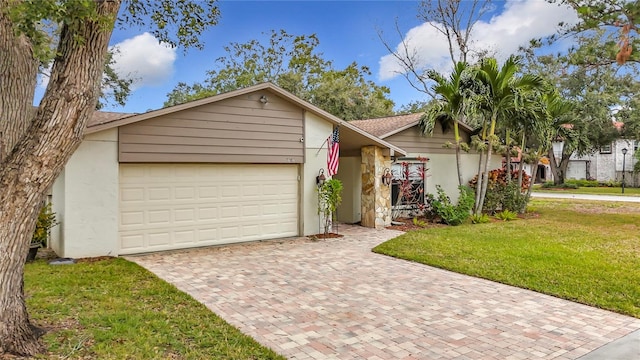 view of front of home featuring a garage and a front lawn