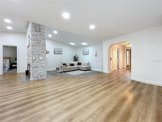 living room with vaulted ceiling and light hardwood / wood-style flooring