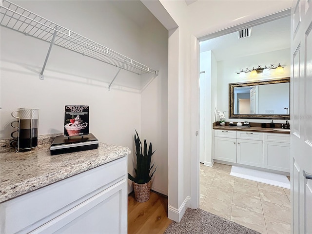 clothes washing area featuring sink and light tile patterned floors