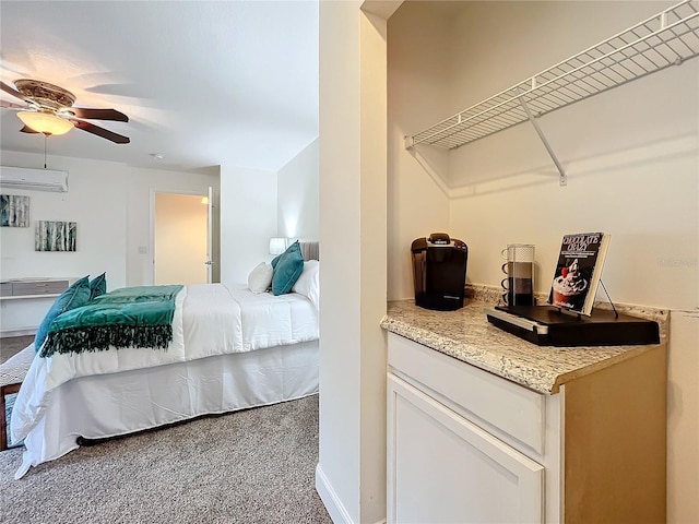 carpeted bedroom featuring a wall mounted air conditioner and ceiling fan