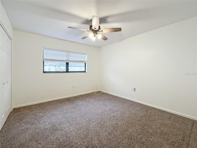 carpeted empty room featuring ceiling fan