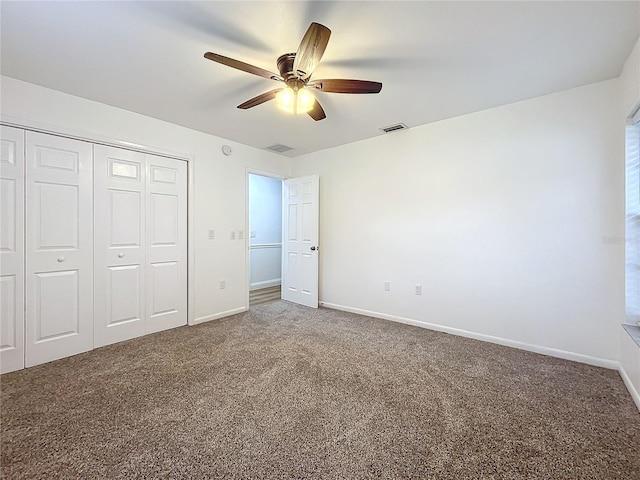 unfurnished bedroom featuring ceiling fan, a closet, and carpet