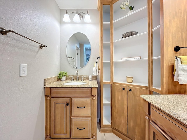 bathroom with tile patterned flooring and vanity