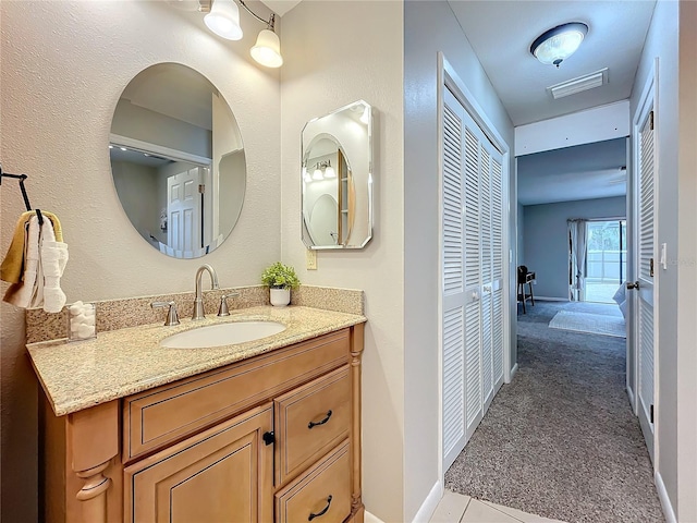 bathroom with tile patterned floors and vanity