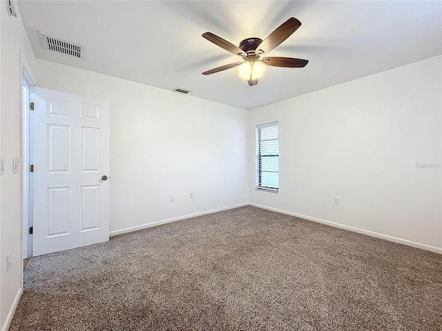 carpeted spare room featuring ceiling fan