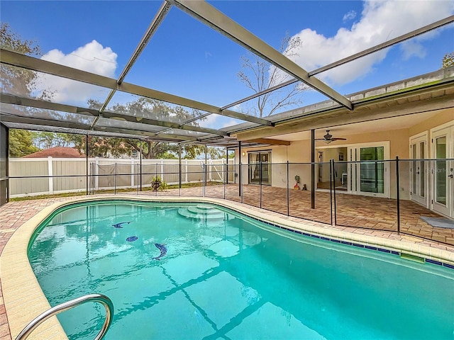 view of swimming pool with french doors, a patio area, and glass enclosure