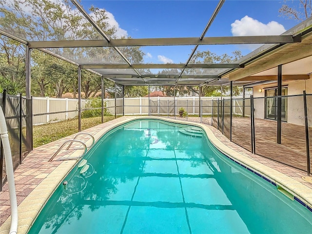 view of swimming pool with a patio area and glass enclosure