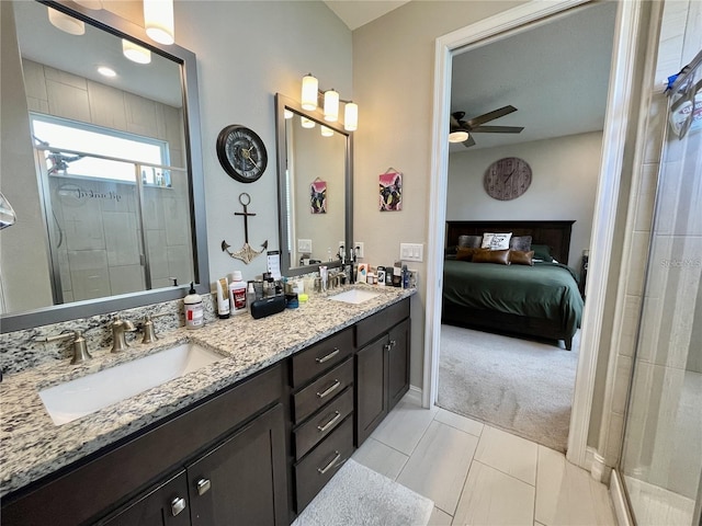 bathroom with walk in shower, ceiling fan, tile patterned floors, and vanity