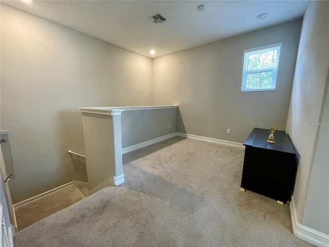 spare room with light colored carpet