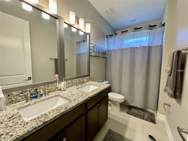 bathroom with vanity, toilet, and tile patterned flooring