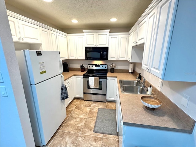 kitchen featuring a textured ceiling, stainless steel range with electric cooktop, white cabinetry, white fridge, and sink