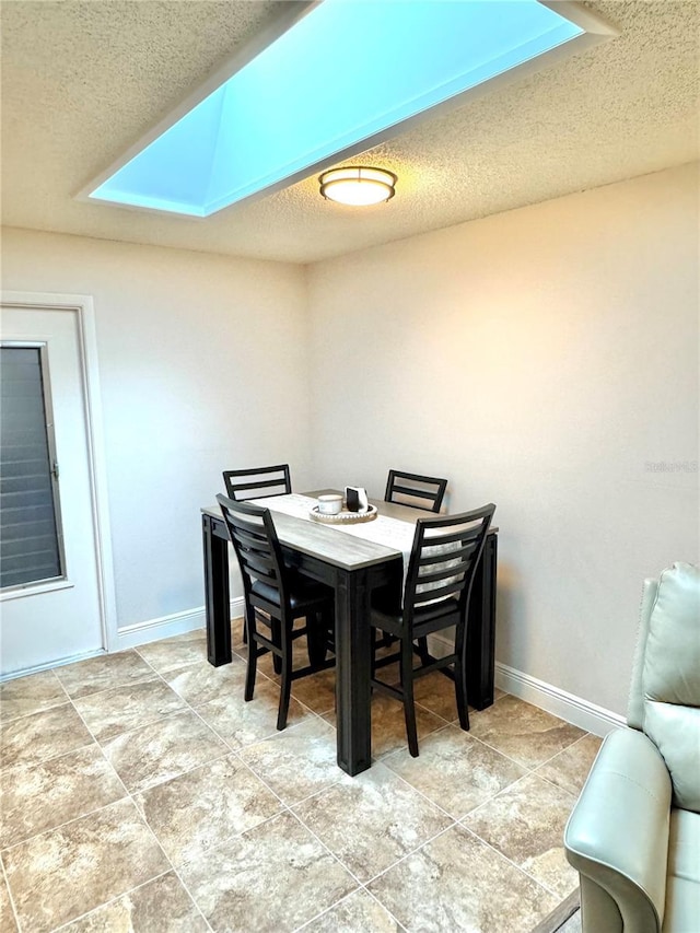 dining area featuring a textured ceiling