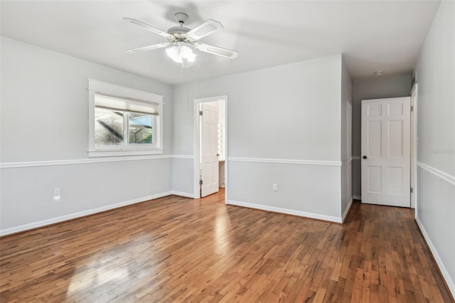 unfurnished bedroom featuring wood-type flooring, ceiling fan, and baseboards