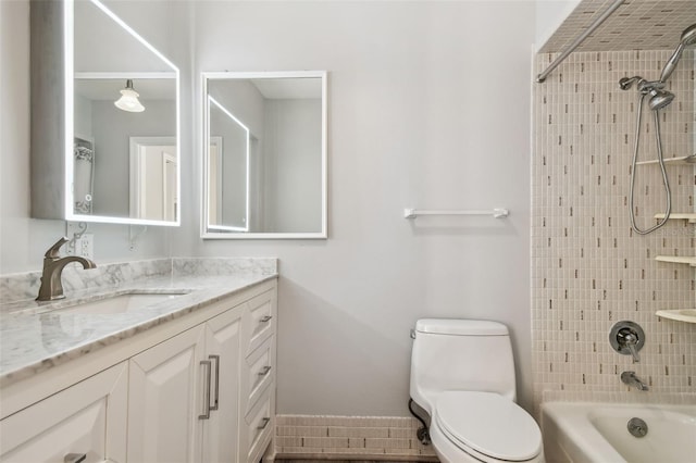 bathroom with toilet, vanity, baseboards, and shower / bathtub combination