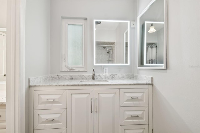 full bathroom with walk in shower and vanity