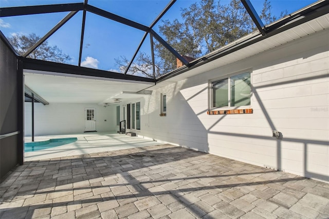 rear view of house with a patio area, a lanai, and a ceiling fan