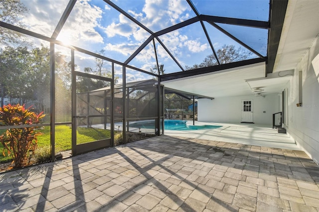 exterior space featuring glass enclosure and an outdoor pool