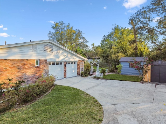 view of side of property featuring concrete driveway, a lawn, an outdoor structure, a shed, and brick siding