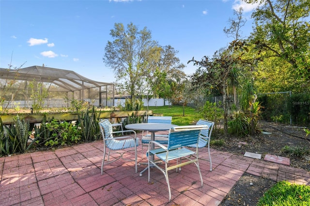 view of patio with outdoor dining space and fence