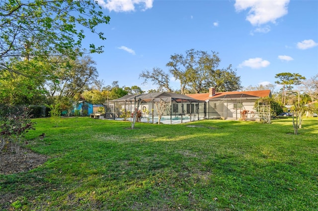 view of yard featuring glass enclosure and an outdoor pool