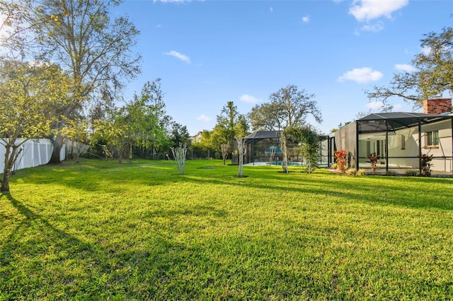 view of yard featuring a lanai and a fenced backyard