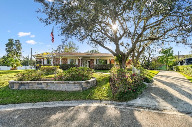 view of front of property with brick siding and a front yard