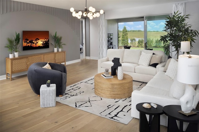 living room featuring a chandelier and light hardwood / wood-style floors