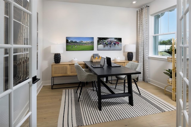 office with light hardwood / wood-style flooring