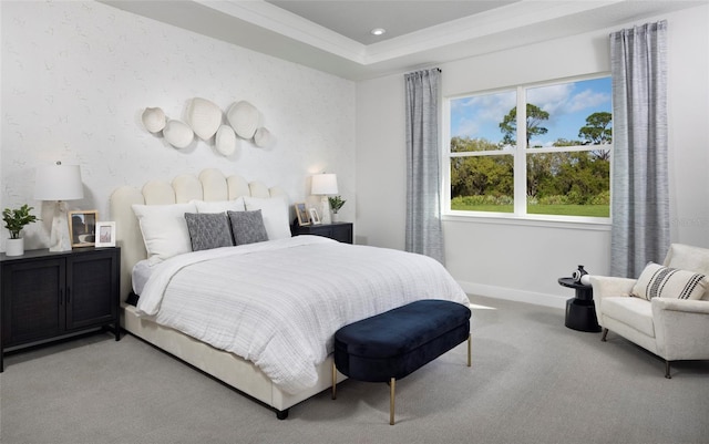 carpeted bedroom with a raised ceiling and crown molding