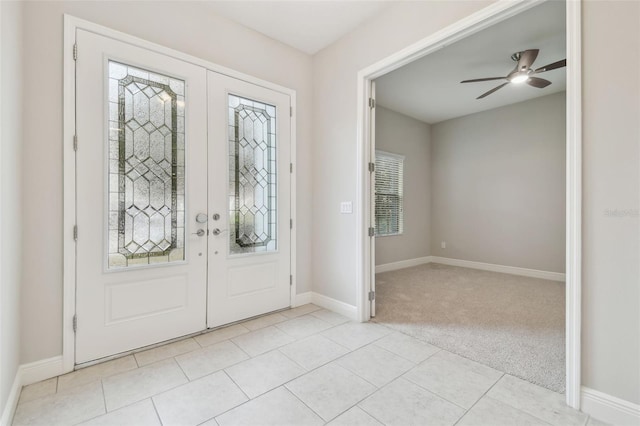 carpeted entryway featuring ceiling fan and french doors