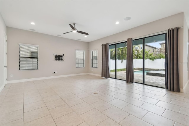 tiled spare room featuring ceiling fan