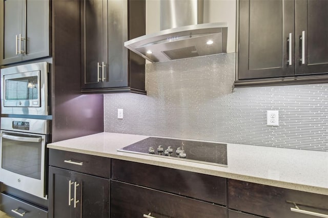 kitchen featuring dark brown cabinets, backsplash, extractor fan, and black electric cooktop