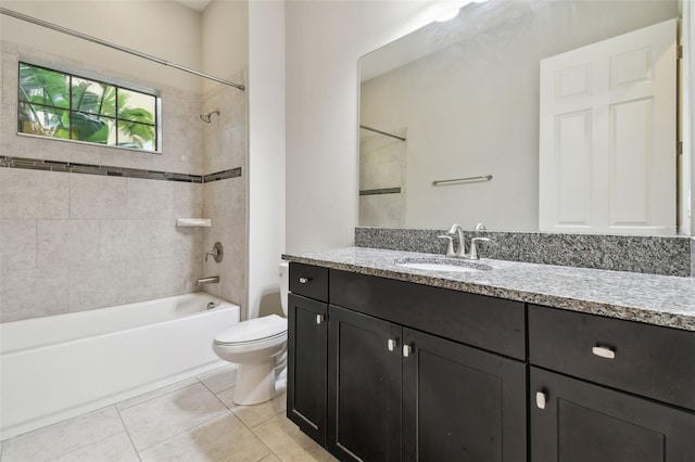 full bathroom with tiled shower / bath combo, toilet, tile patterned floors, and vanity