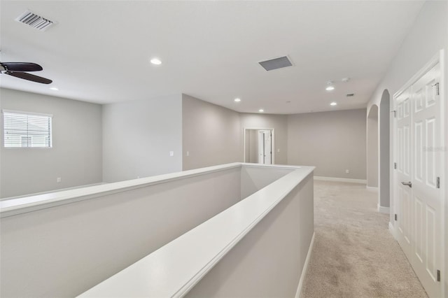 hallway with light colored carpet