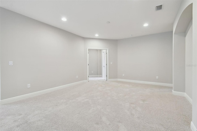 spare room featuring light colored carpet