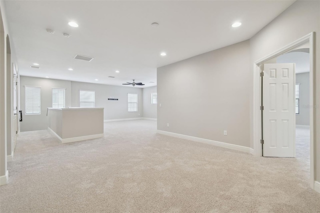 empty room with light colored carpet and ceiling fan