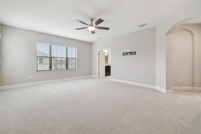 carpeted spare room featuring ceiling fan