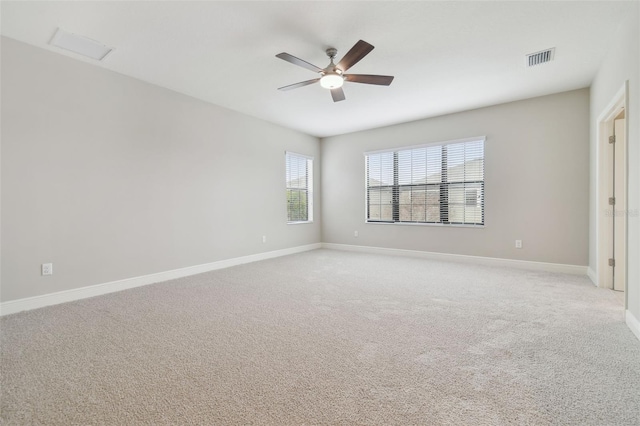 carpeted spare room with ceiling fan