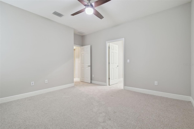 carpeted spare room featuring ceiling fan