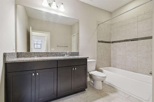 full bathroom with tiled shower / bath combo, toilet, tile patterned flooring, and vanity