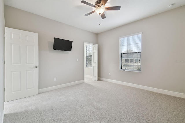 carpeted empty room with ceiling fan