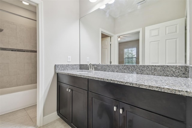 bathroom featuring tiled shower / bath, tile patterned floors, ceiling fan, and vanity