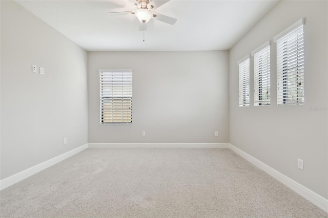 empty room featuring ceiling fan and carpet floors