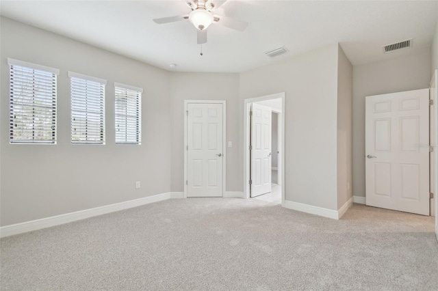 unfurnished bedroom with light colored carpet and ceiling fan