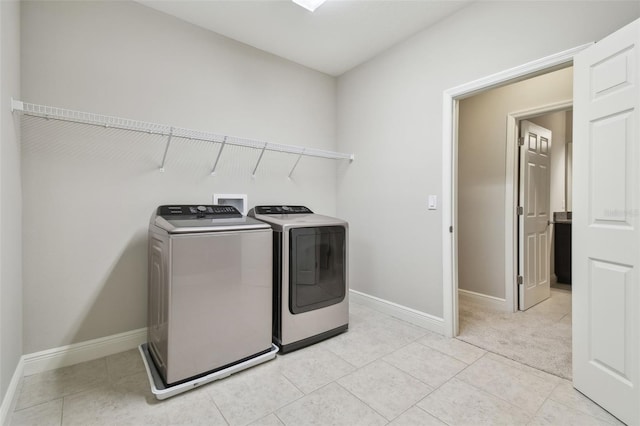 laundry room featuring light carpet and washing machine and dryer