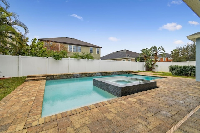 view of pool with an in ground hot tub and a patio area