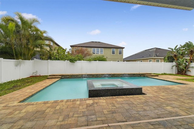 view of swimming pool with an in ground hot tub and a patio area