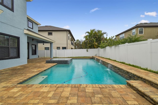 view of swimming pool featuring a patio area, a jacuzzi, and pool water feature